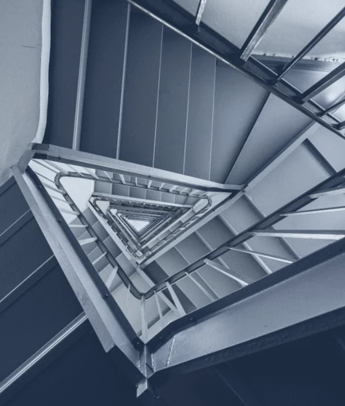 A stairwell seen from below, flights rising floor over floor.