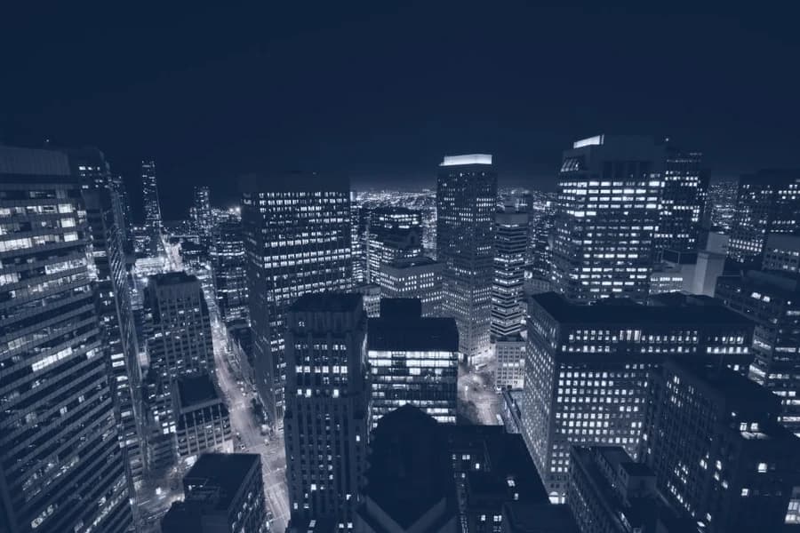 A business district at night, office towers still lit.