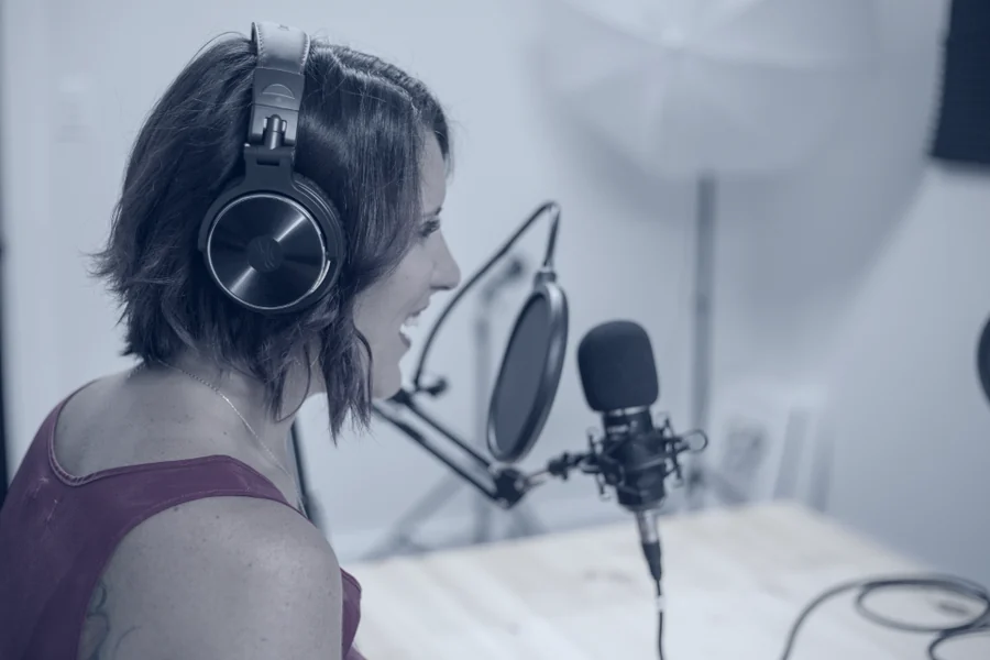 A microphone and headphones set up in a recording booth.